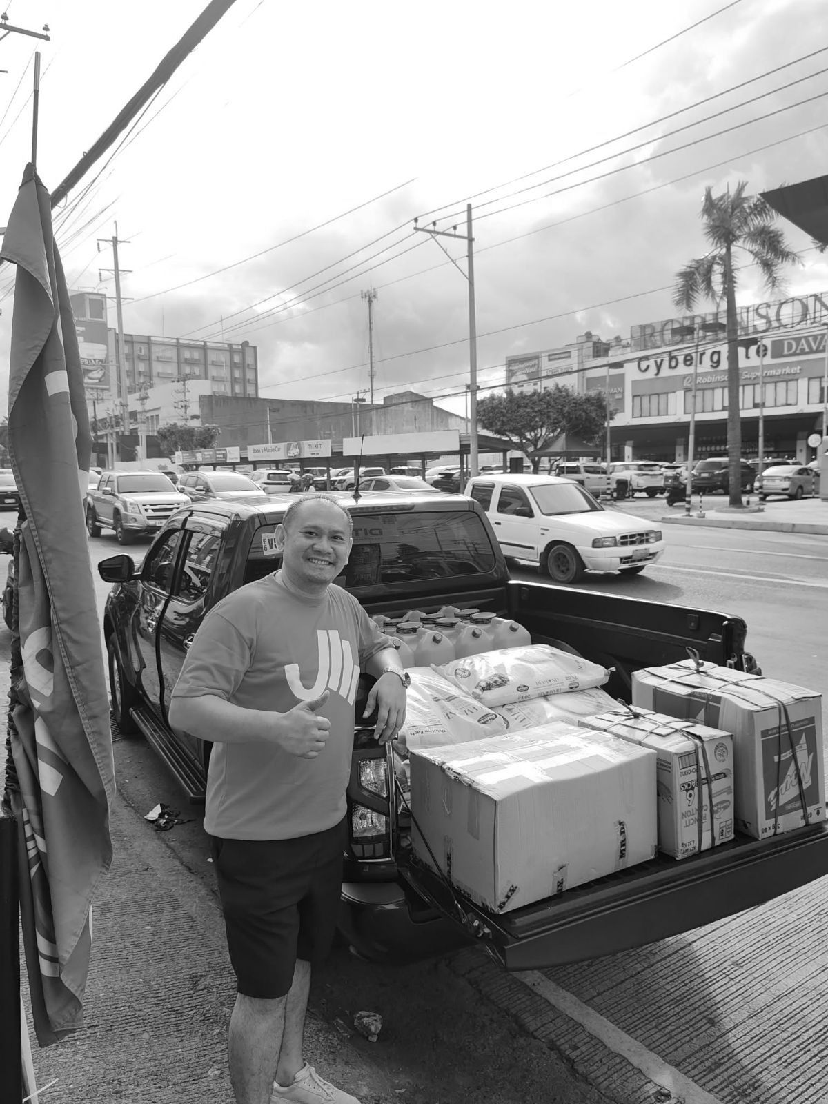 An Aid Meridian volunteer with a truck loaded with relief supplies in Davao City